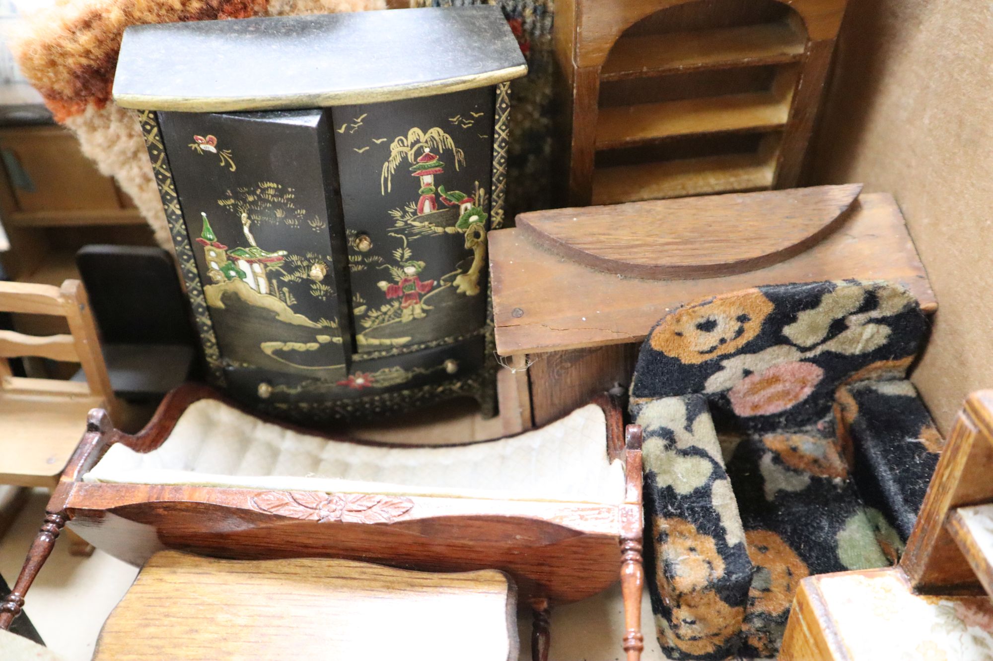 A collection of dolls and dolls house furniture displayed in room settings in a pine cupboard, width 84cm, depth 36cm, height 132cm